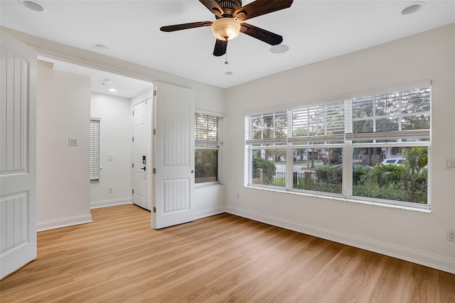 unfurnished room with ceiling fan and light wood-type flooring