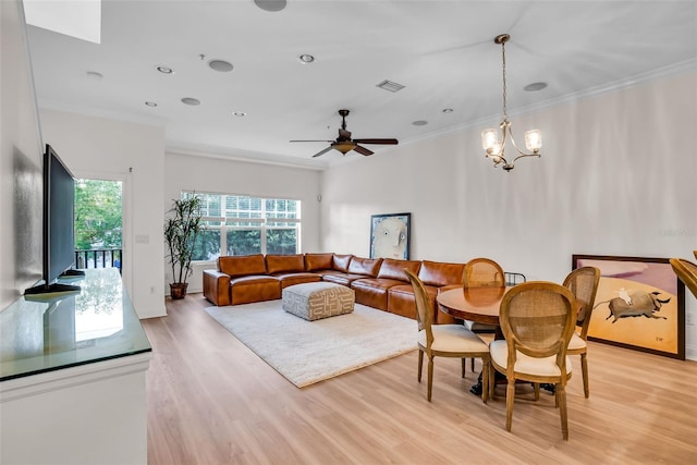 interior space with plenty of natural light, crown molding, and light wood-type flooring