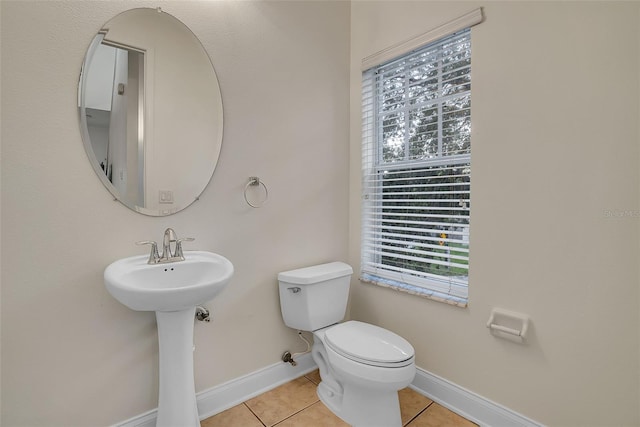 bathroom with toilet and tile floors