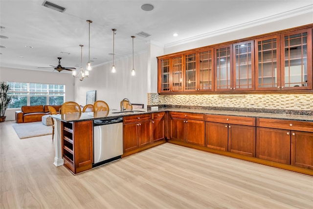 kitchen with tasteful backsplash, light hardwood / wood-style flooring, and dishwasher