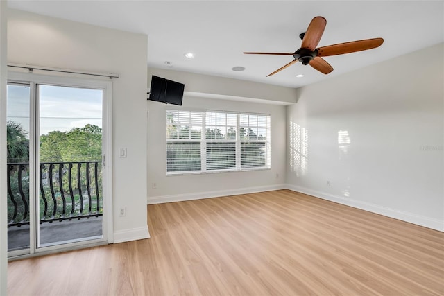 spare room featuring light hardwood / wood-style flooring and ceiling fan