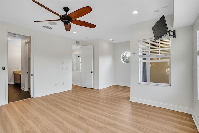 spare room featuring light hardwood / wood-style flooring and ceiling fan