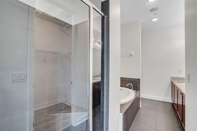 bathroom featuring vanity, shower with separate bathtub, and tile flooring