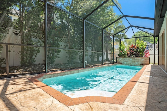 view of pool with a lanai and a patio area