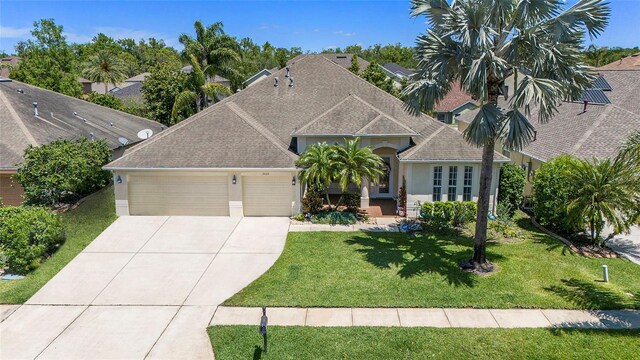 view of front of house with a garage and a front lawn