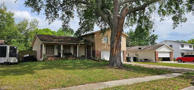 tri-level home with a garage and a front lawn