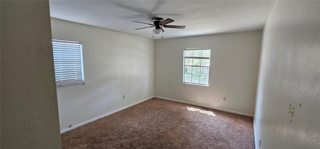 carpeted empty room with baseboards and ceiling fan