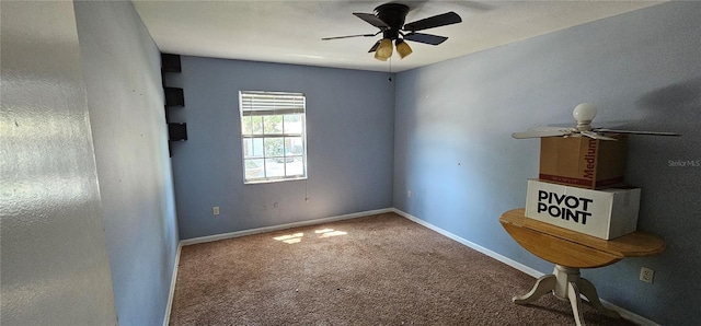 spare room featuring baseboards, carpet, and a ceiling fan