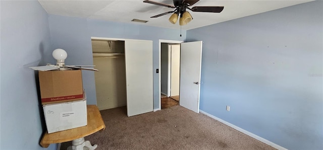 unfurnished bedroom with visible vents, a closet, carpet floors, baseboards, and ceiling fan