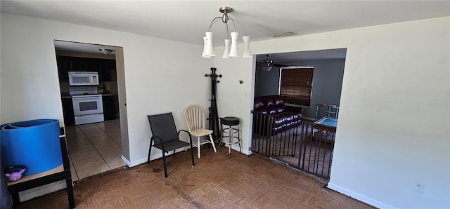 tiled dining space with baseboards and visible vents