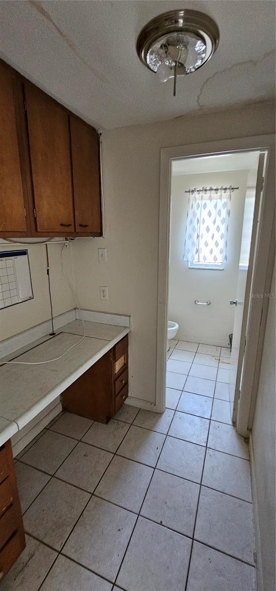 bathroom with tile patterned floors, a textured ceiling, and toilet