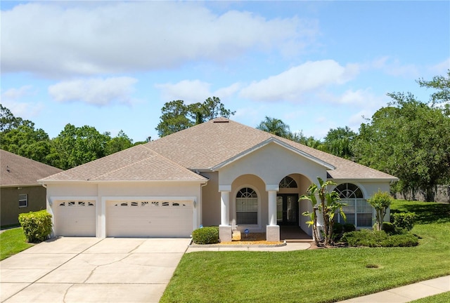 view of front of house featuring a garage and a front lawn