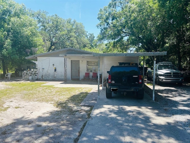 single story home featuring a carport