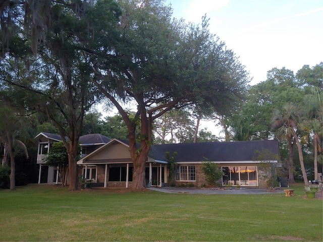 back of house featuring a lawn