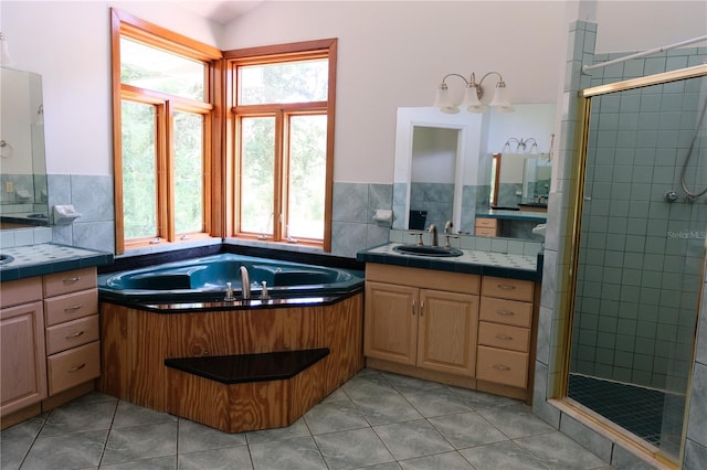 bathroom featuring tile floors, walk in shower, backsplash, and vanity