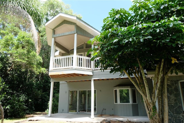 back of house with a patio and a balcony