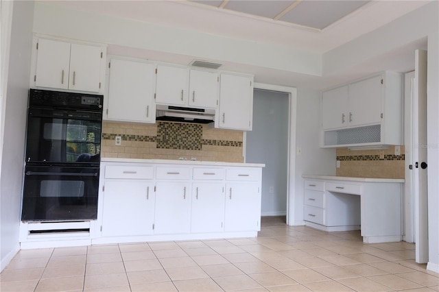 kitchen with white cabinetry, backsplash, and double oven