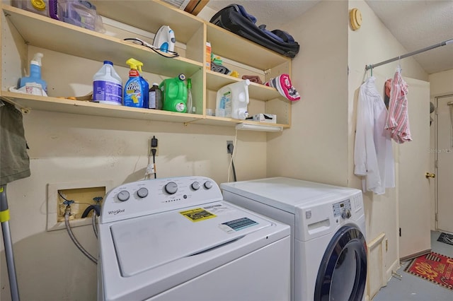 washroom with a textured ceiling, independent washer and dryer, hookup for an electric dryer, and washer hookup