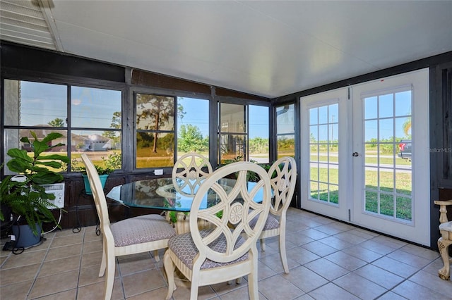 sunroom / solarium featuring french doors and a healthy amount of sunlight