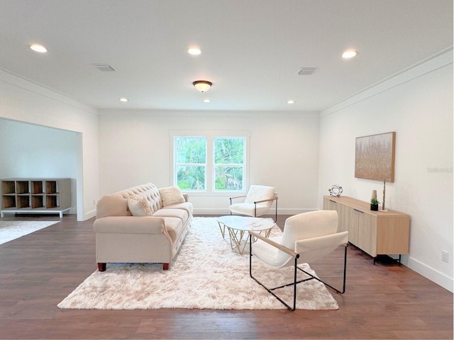 living room with dark hardwood / wood-style floors and ornamental molding