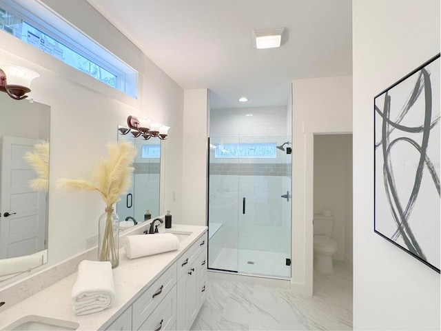 bathroom featuring a shower with door, tile flooring, double vanity, and toilet