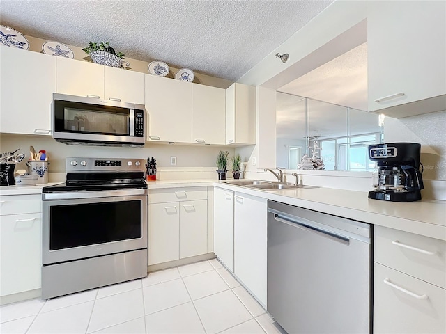 kitchen featuring appliances with stainless steel finishes, sink, and white cabinets