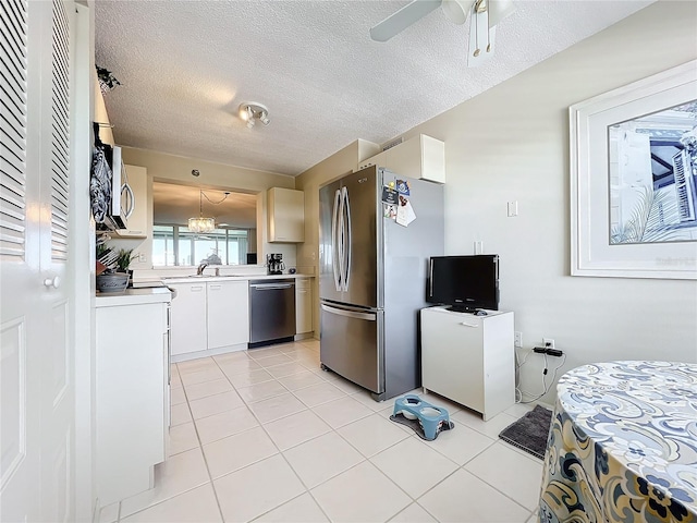 kitchen with white cabinets, sink, appliances with stainless steel finishes, and light tile floors