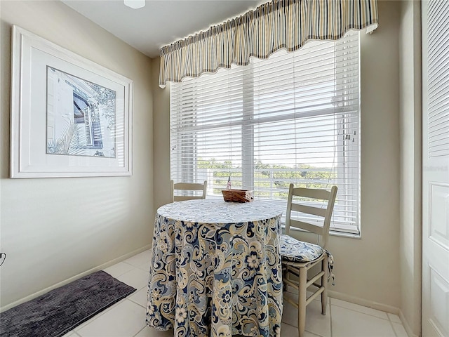 dining space featuring light tile floors