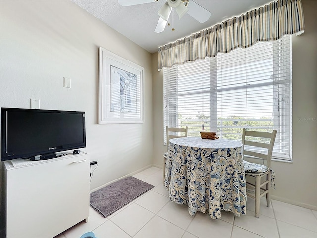 tiled dining room featuring ceiling fan