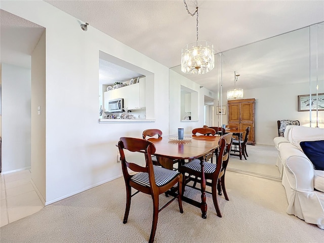 carpeted dining space with an inviting chandelier