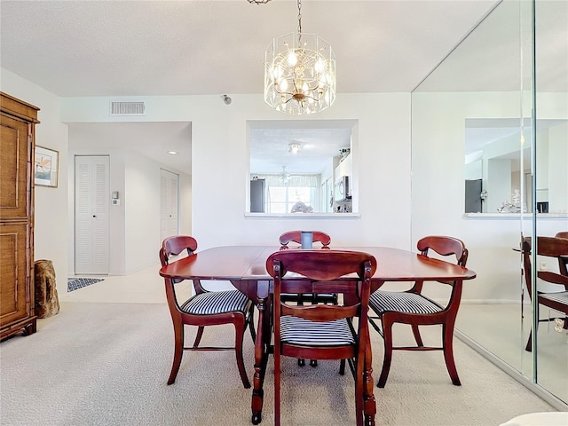 dining room featuring an inviting chandelier and light carpet