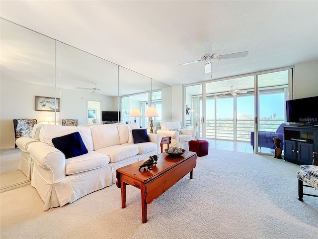 living room with light colored carpet, ceiling fan, and expansive windows