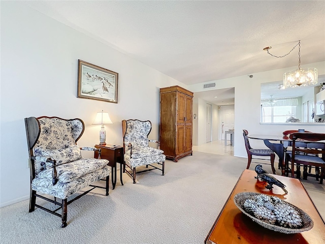 living area with light carpet and an inviting chandelier