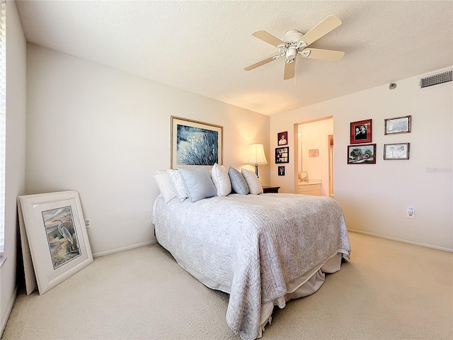 carpeted bedroom with a textured ceiling and ceiling fan