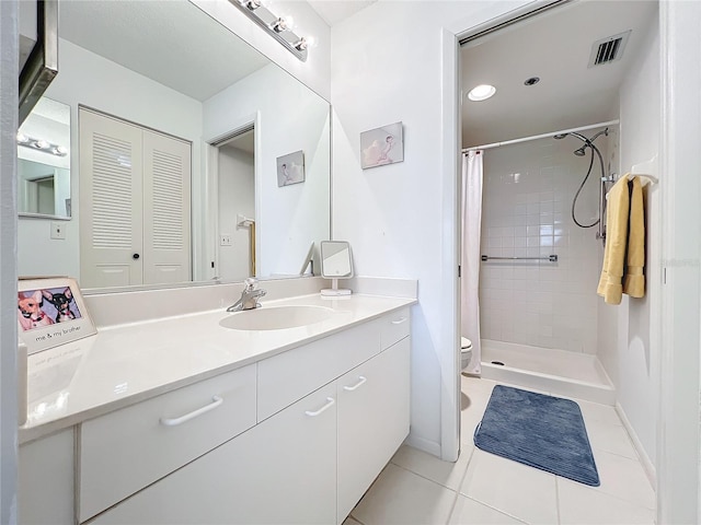 bathroom featuring a shower with curtain, tile floors, vanity, and toilet