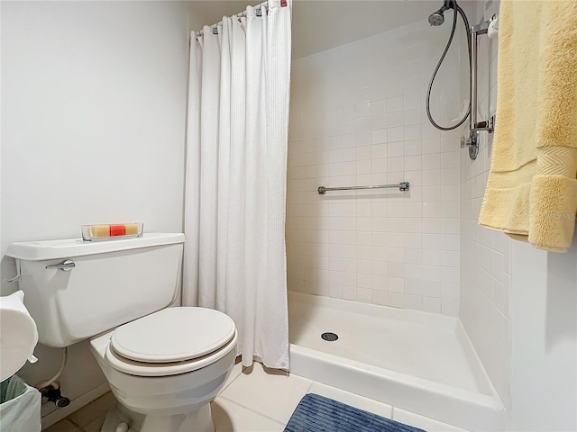 bathroom with walk in shower, tile floors, and toilet