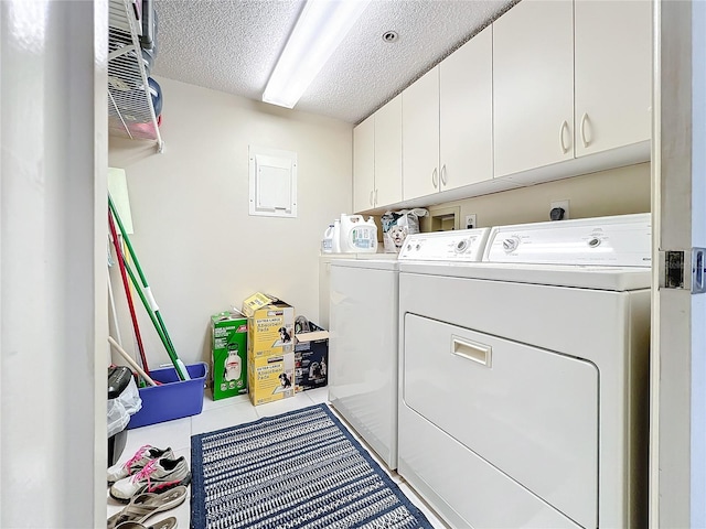 clothes washing area with cabinets, a textured ceiling, washing machine and dryer, washer hookup, and hookup for an electric dryer