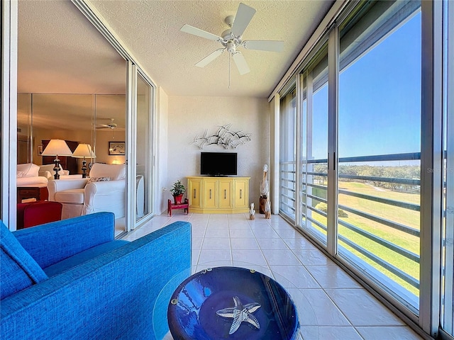 sunroom featuring ceiling fan