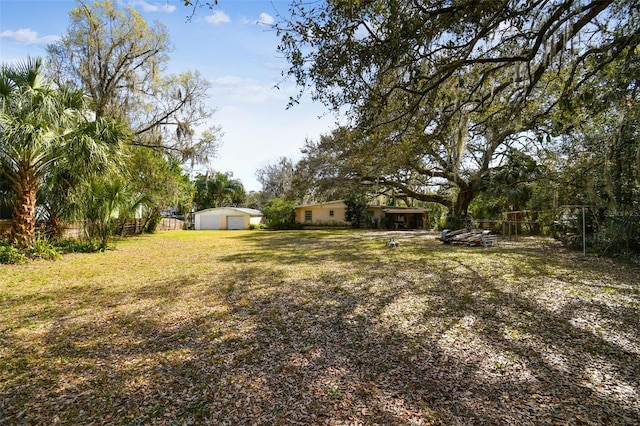 view of yard featuring a garage and an outdoor structure