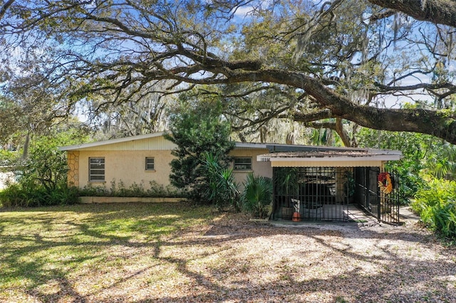 exterior space with a carport and a front yard