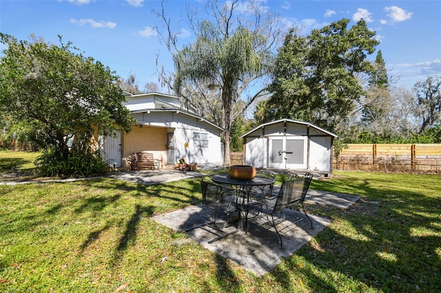 view of yard featuring a patio area and a storage shed