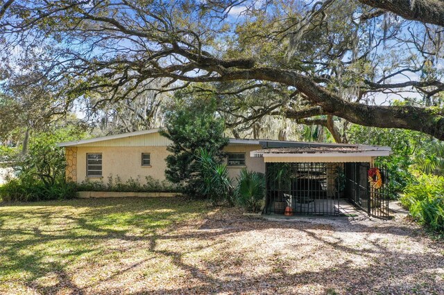 exterior space featuring a front lawn and a carport