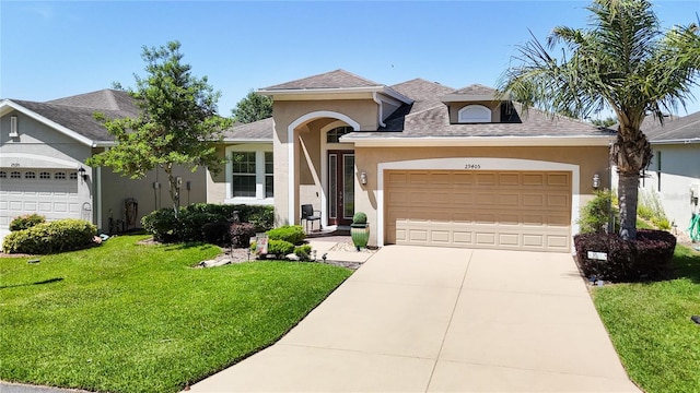 view of front of home featuring a garage and a front lawn