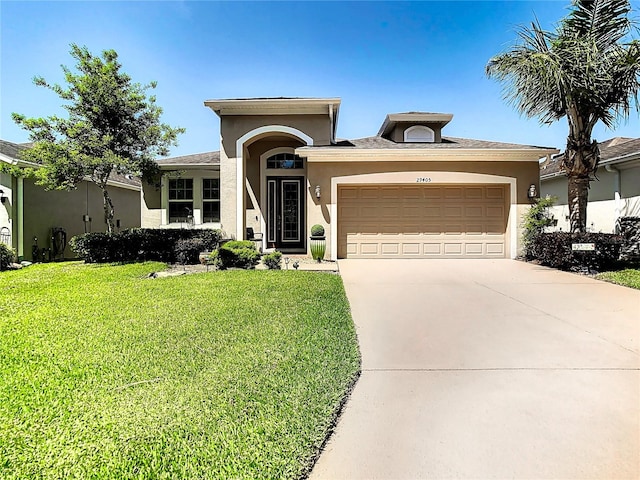 view of front of home with a garage and a front yard