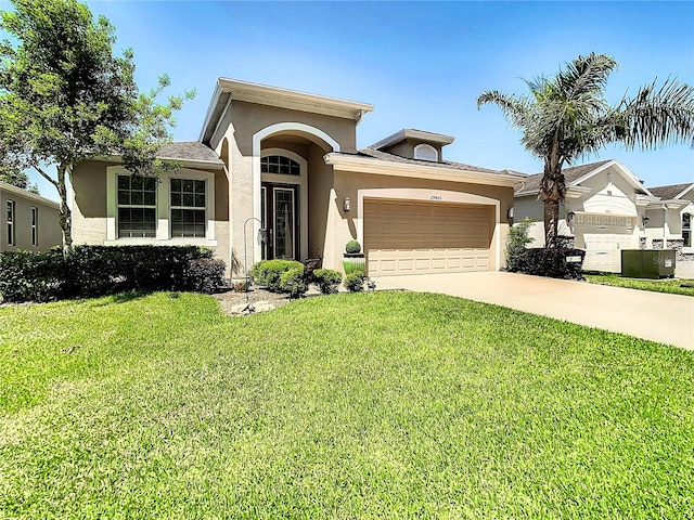 view of front of home featuring a garage and a front lawn