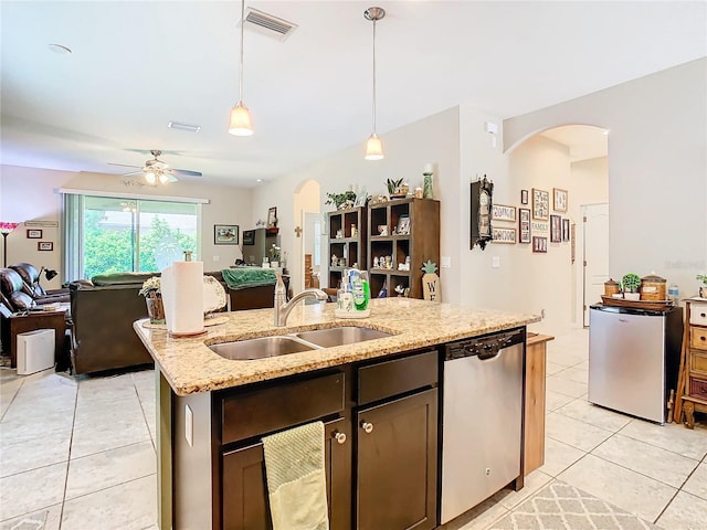 kitchen with decorative light fixtures, a kitchen island with sink, sink, stainless steel dishwasher, and ceiling fan