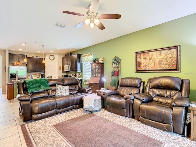 tiled living room with ceiling fan