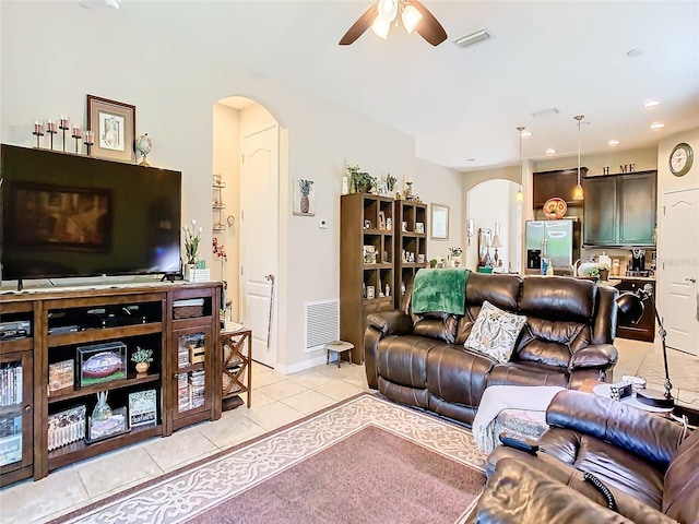 tiled living room featuring ceiling fan