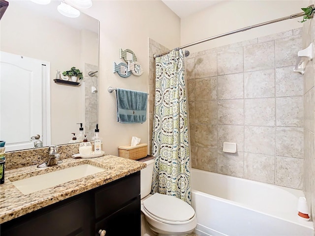 full bathroom with vanity, shower / tub combo, and toilet