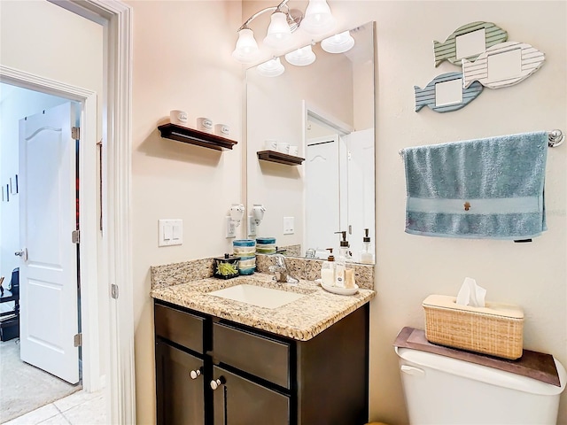 bathroom featuring large vanity, toilet, and tile flooring